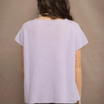 a woman wears a cashmere tee sweater with a moss texture in light pale purple