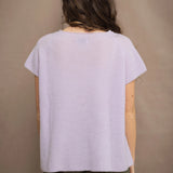 a woman wears a cashmere tee sweater with a moss texture in light pale purple