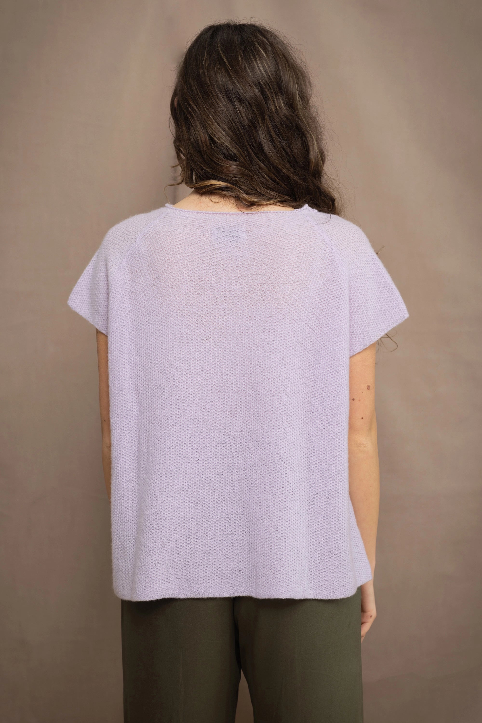 a woman wears a cashmere tee sweater with a moss texture in light pale purple