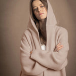 A woman wears a pure cashmere hooded cardigan coat in beige