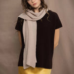 a woman wears a cashmere scarf in beige by Irish brand Madigan Cashmere over a cashmere tee in dark brown 