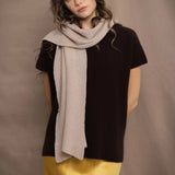 a woman wears a cashmere scarf in beige by Irish brand Madigan Cashmere over a cashmere tee in dark brown 