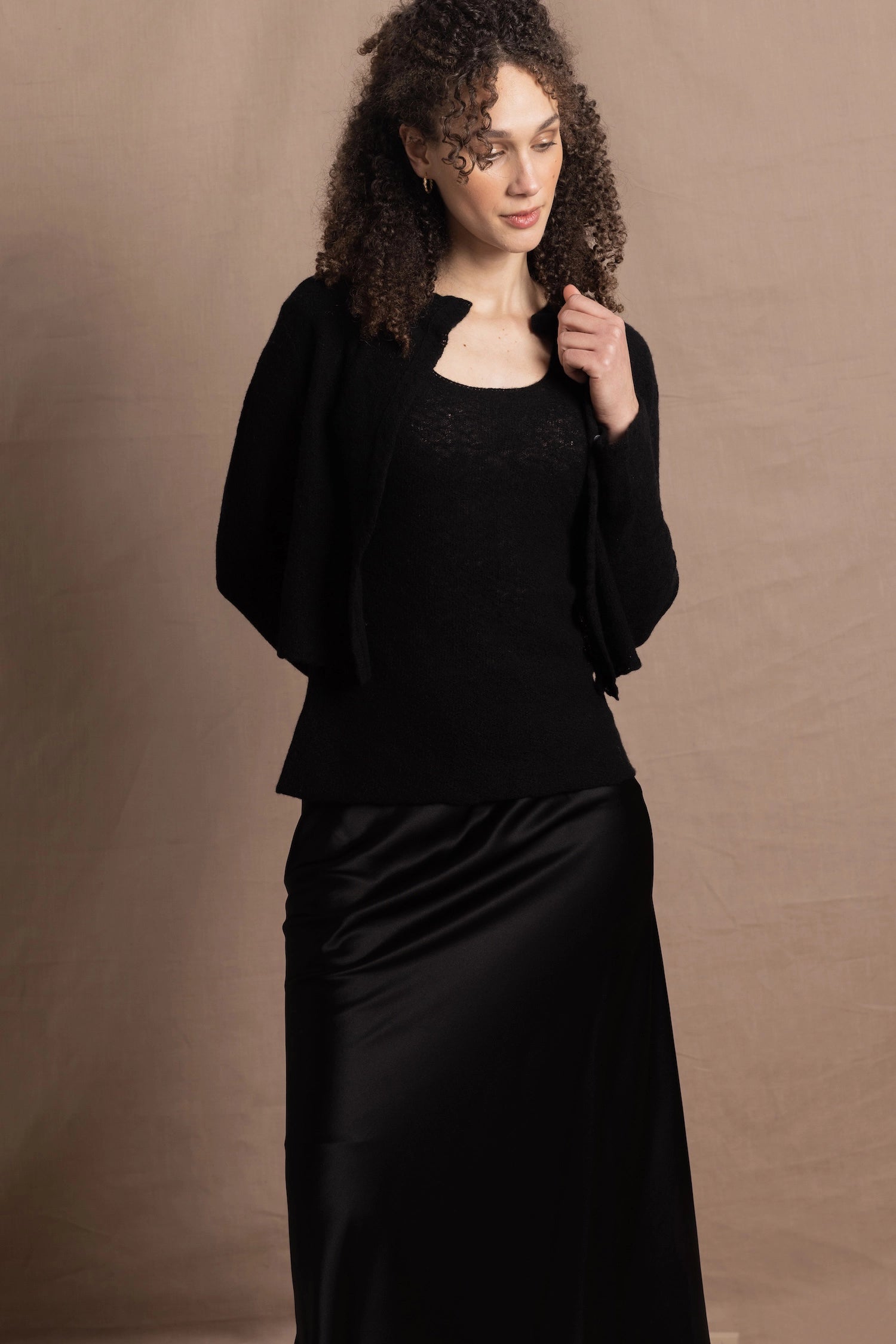 a cashmere lace cardigan sweater in black  with black silk skirt