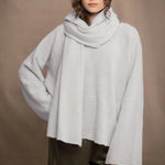woman wears a white cashmere wrap shawl with pointelle texture 