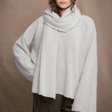 woman wears a white cashmere wrap shawl with pointelle texture 