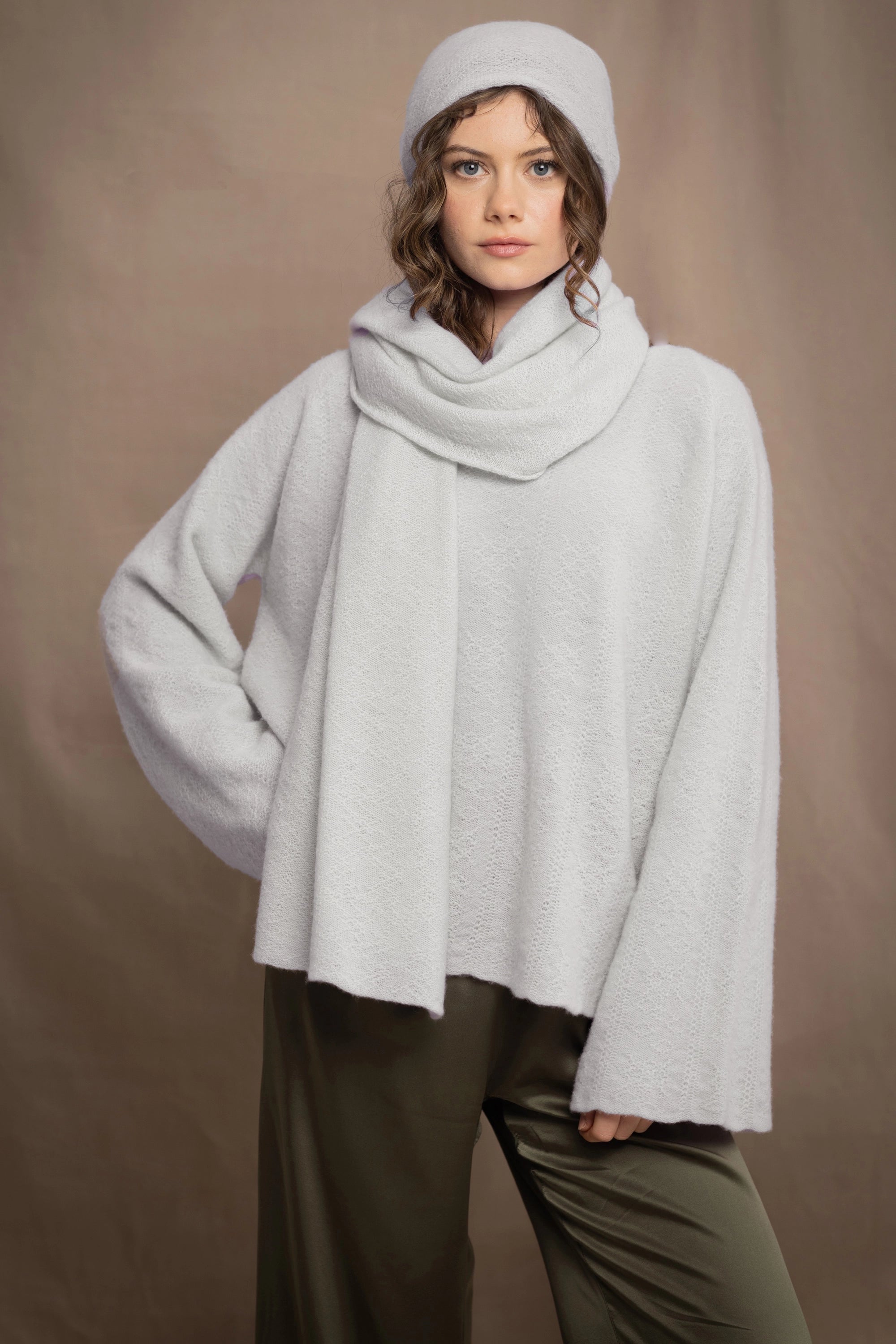 woman wears a white cashmere wrap shawl with pointelle texture 