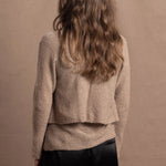 A woman wears a pure cashmere twinset cardigan with matching vest top in Beige with silk shorts in black