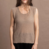 A woman wears a 100% pure cashmere sleeveless vest top in beige