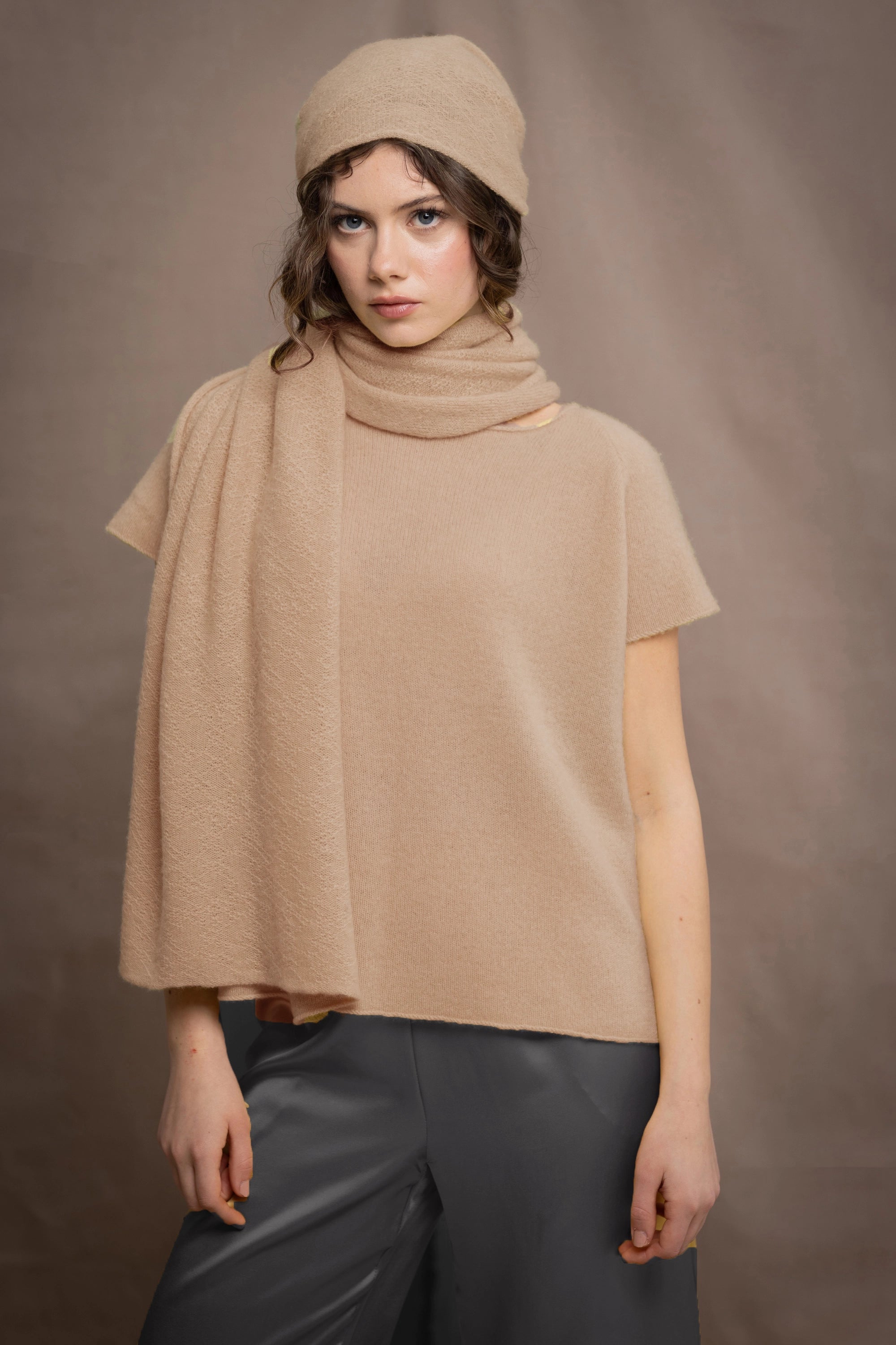 a woman wears a cashmere tee sweater in beige sandy colour
