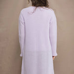 Woman wears a light purple cashmere cardigan coat over a matching cashmere tee sweater by Irish brand Madigan