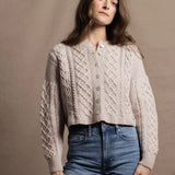 A lady wears a pure 100% cashmere Irish aran sweater cardigan in soft pink 