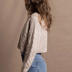 A lady wears a pure 100% cashmere Irish aran sweater cardigan in soft pink 