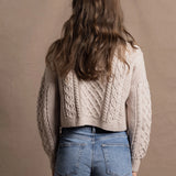 A lady wears a pure 100% cashmere Irish aran sweater cardigan in soft pink 