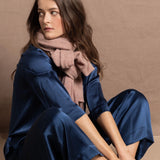a small 100% cashmere scarf in blush pink over a teal 100% silk top and matching trousers