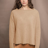 a woman wears a cashmere sweater in sandy beige colour