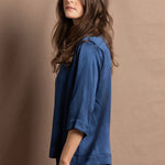 A lady wears a pure silk 3/4 sleeve blouse in teal with matching trousers