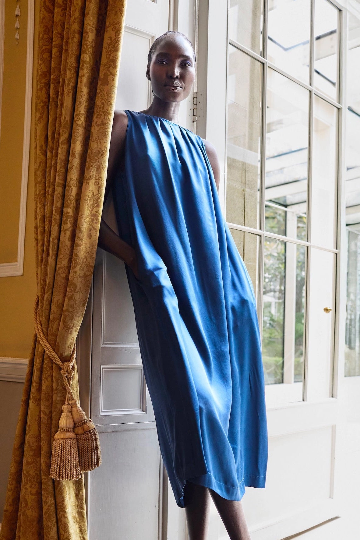 Woman in a luxurious blue silk dress
