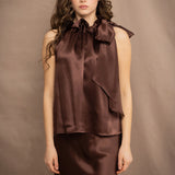 a woman wears a pure 100% silk halter top in chocolate brown with matching silk skirt