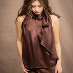 a woman wears a pure 100% silk halter top in chocolate brown with matching silk skirt