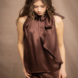 a woman wears a pure 100% silk halter top in chocolate brown with matching silk skirt