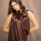 a woman wears a pure 100% silk halter top in chocolate brown with matching silk skirt