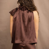 a woman wears a pure 100% silk halter top in chocolate brown with matching silk skirt