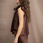 a woman wears a pure 100% silk halter top in chocolate brown with matching silk skirt