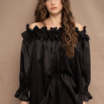 a woman wears a black silk ruffle blouse handmade in Ireland