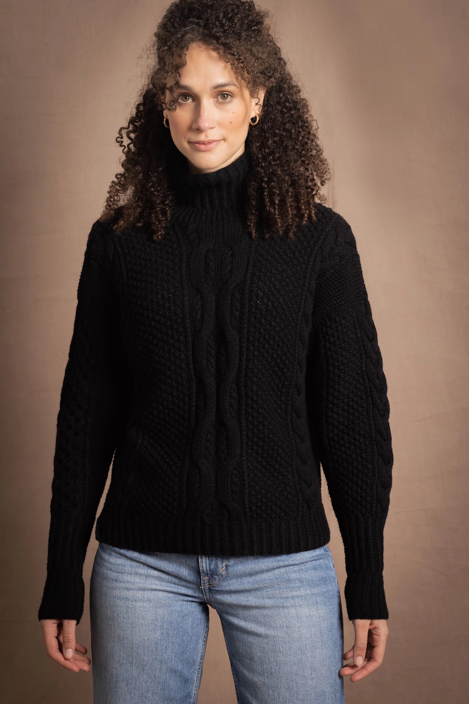 Woman wears traditional Irish Cashmere Aran Sweater in Black