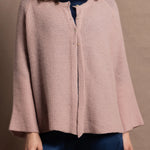 a 100% cashmere button down swing cardigan with moss stitch texture in dusty pink paired with navy blue silk top and trousers