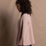 a 100% cashmere button down swing cardigan with moss stitch texture in dusty pink paired with navy blue silk top and trousers