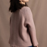 a 100% cashmere button down swing cardigan with moss stitch texture in dusty pink paired with navy blue silk top and trousers