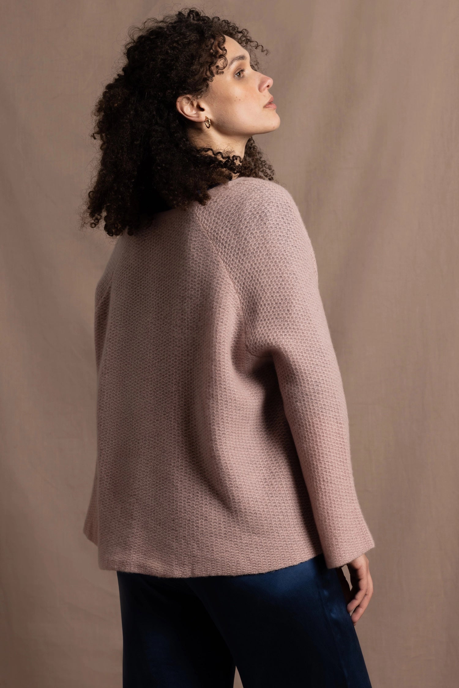 a 100% cashmere button down swing cardigan with moss stitch texture in dusty pink paired with navy blue silk top and trousers
