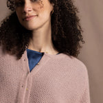 A close up shot of 100% cashmere button down swing cardigan with moss stitch texture in dusty pink