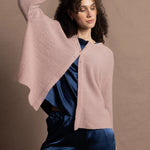 a 100% cashmere button down swing cardigan with moss stitch texture in dusty pink paired with navy blue silk top and trousers
