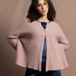 a 100% cashmere button down swing cardigan with moss stitch texture in dusty pink paired with navy blue silk top and trousers