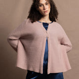 a 100% cashmere button down swing cardigan with moss stitch texture in dusty pink paired with navy blue silk top and trousers