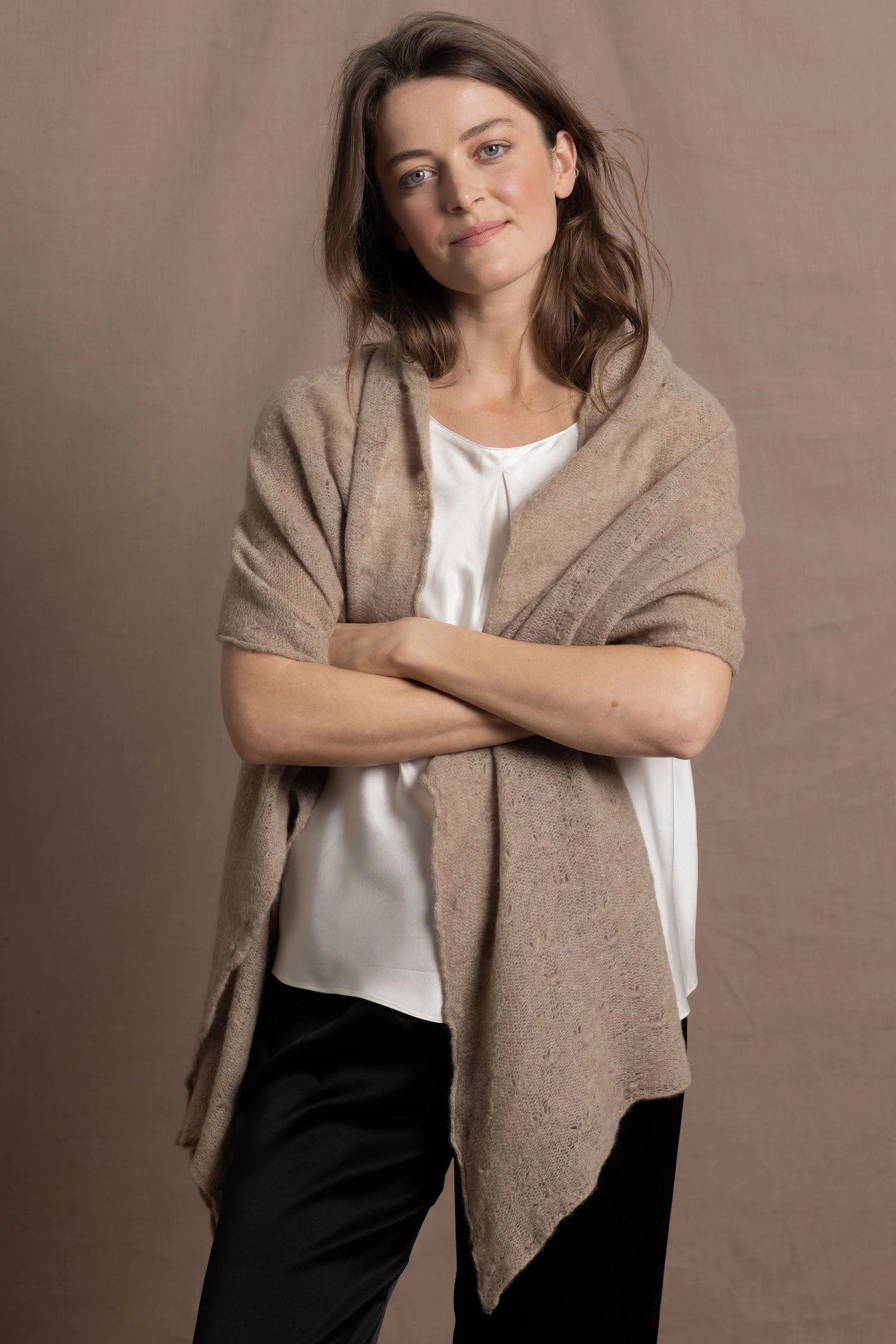 lightweight cashmere wrap shawl in neutral colour worn over white silk top and black silk trousers
