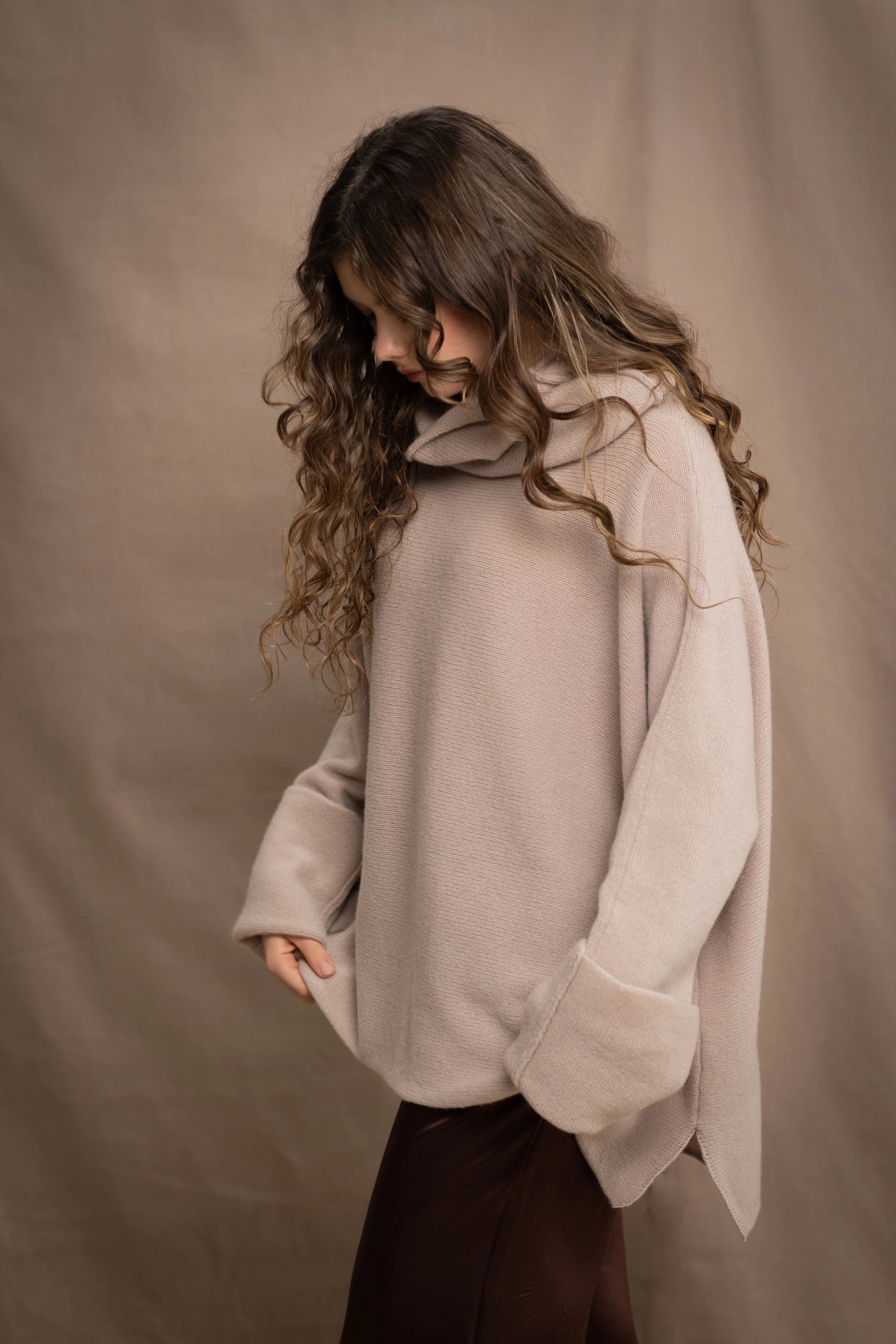a woman wears an oversized 100% cashmere sweater in beige by Irish brand Madigan Cashmere