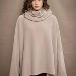 a woman wears an oversized 100% cashmere sweater in beige by Irish brand Madigan Cashmere