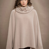 a woman wears an oversized 100% cashmere sweater in beige by Irish brand Madigan Cashmere