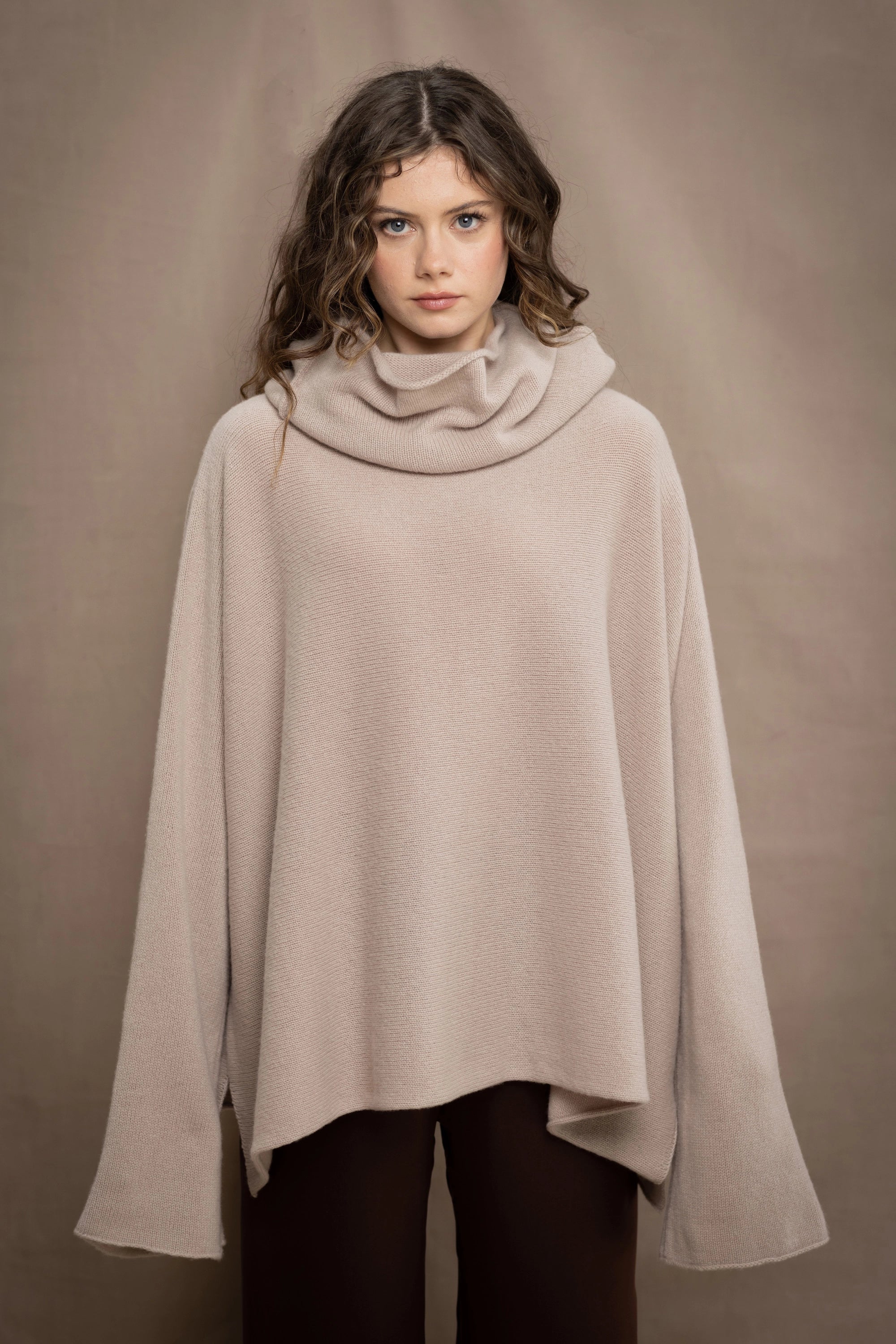 a woman wears an oversized 100% cashmere sweater in beige by Irish brand Madigan Cashmere
