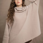 a woman wears an oversized 100% cashmere sweater in beige by Irish brand Madigan Cashmere