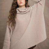 a woman wears an oversized 100% cashmere sweater in beige by Irish brand Madigan Cashmere