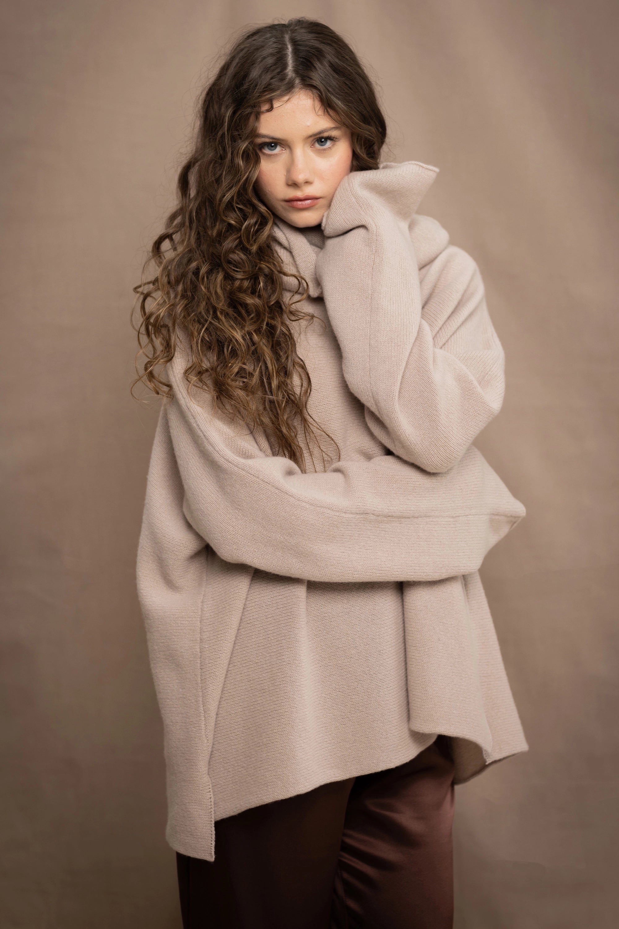 a woman wears an oversized 100% cashmere sweater in beige by Irish brand Madigan Cashmere