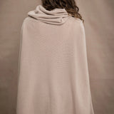 a woman wears an oversized 100% cashmere sweater in beige by Irish brand Madigan Cashmere