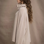 a woman wears an oversized 100% cashmere sweater in beige by Irish brand Madigan Cashmere