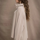 a woman wears an oversized 100% cashmere sweater in beige by Irish brand Madigan Cashmere