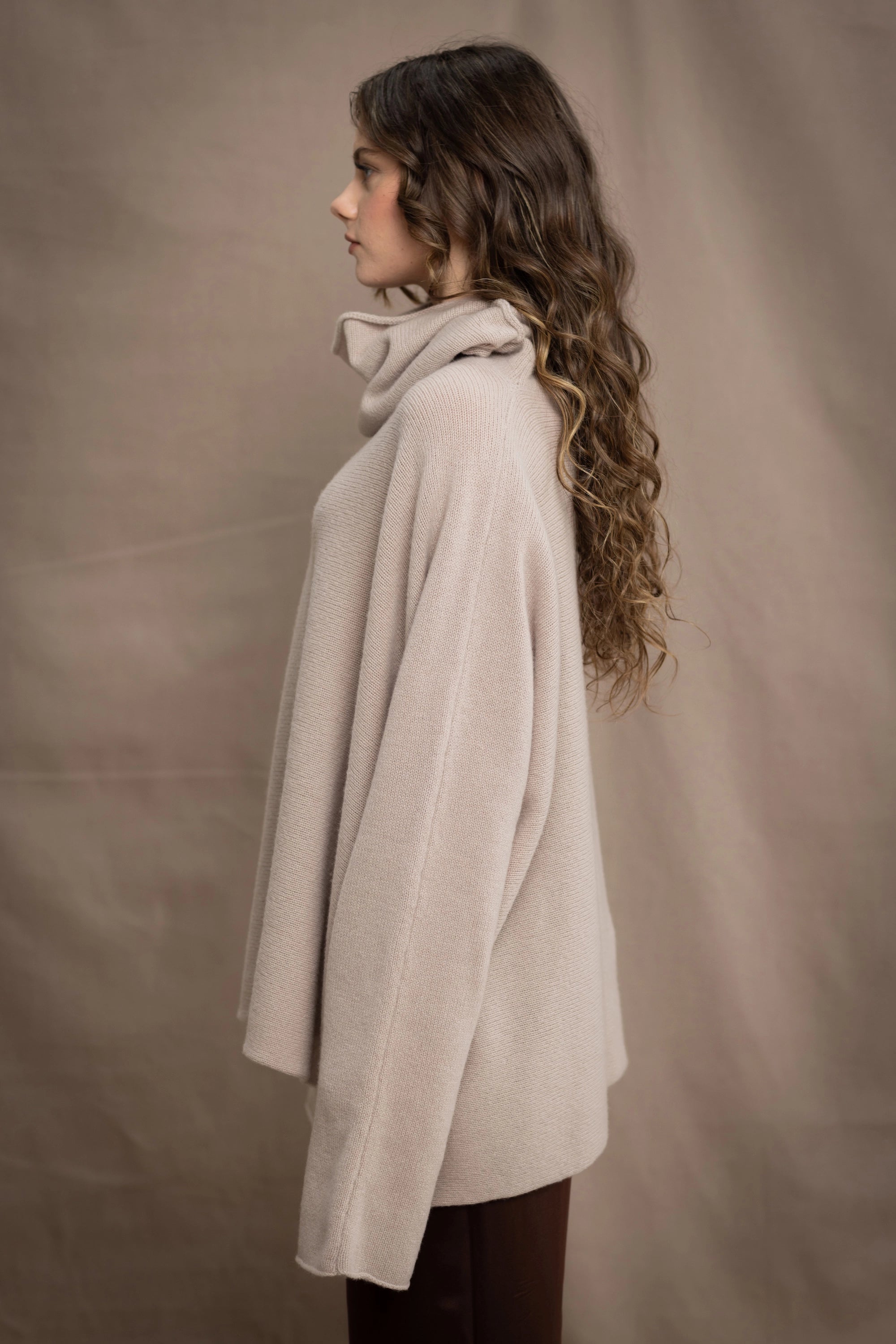a woman wears an oversized 100% cashmere sweater in beige by Irish brand Madigan Cashmere
