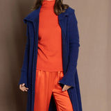 cashmere lace coat in blue over orange turtleneck and orange silk pants